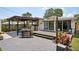 Backyard showing a deck with outdoor seating, patio, plantings, and servery area, ideal for outdoor living at 511 Glenoak N St, St Petersburg, FL 33703