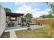 Large backyard featuring a dining area, a fire pit, outdoor servery area, and grassy space at 511 Glenoak N St, St Petersburg, FL 33703