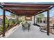 Spacious backyard with a covered patio, dining set, outdoor servery area, and a hammock at 511 Glenoak N St, St Petersburg, FL 33703