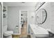 Contemporary bathroom with toilet and vanity with drawers, adjacent to the living areas in an open floor plan at 511 Glenoak N St, St Petersburg, FL 33703