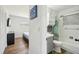 Bathroom featuring gray vanity with drawers and cabinets, toilet and shower-tub combo with blue shower curtain at 511 Glenoak N St, St Petersburg, FL 33703
