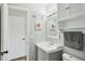 Serene bathroom with gray vanity, stylish wall decor, and a crisp white door at 511 Glenoak N St, St Petersburg, FL 33703