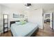 Bright bedroom featuring a queen bed with light blue bedding and direct access to the kitchen at 511 Glenoak N St, St Petersburg, FL 33703