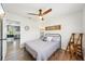 Cozy bedroom with wood-look floors, a ceiling fan, and access to the kitchen, creating a seamless flow at 511 Glenoak N St, St Petersburg, FL 33703