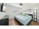 Tranquil bedroom featuring wood-look floors, a modern ceiling fan, and a clean, minimalist design at 511 Glenoak N St, St Petersburg, FL 33703
