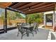 Inviting covered patio with dining table set, ceiling fan, and string lights for relaxing outdoor gatherings at 511 Glenoak N St, St Petersburg, FL 33703