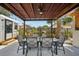 Relaxing covered patio features a dining area and view of the landscaped backyard with mature plantings at 511 Glenoak N St, St Petersburg, FL 33703
