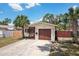 Inviting single-story home with a well-kept lawn, mature palm trees, and a cozy screened entrance at 511 Glenoak N St, St Petersburg, FL 33703