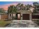 Charming home with a well-manicured lawn, a private drive, and warm exterior lighting at 511 Glenoak N St, St Petersburg, FL 33703