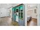 Hallway with modern storage shelves and an open door to a bedroom at 511 Glenoak N St, St Petersburg, FL 33703