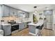 Updated kitchen showcasing sleek gray cabinets, quartz countertops, stainless steel appliances, and a stylish island at 511 Glenoak N St, St Petersburg, FL 33703