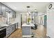 Modern kitchen with gray cabinets, stainless steel appliances, an island with bar seating, and wood flooring at 511 Glenoak N St, St Petersburg, FL 33703