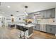 Modern kitchen with gray cabinets, stainless steel appliances, an island with bar seating, and wood flooring at 511 Glenoak N St, St Petersburg, FL 33703