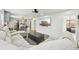 Bright living room showcasing a comfortable sectional sofa, wood floors, and a large television for entertainment at 511 Glenoak N St, St Petersburg, FL 33703