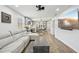Open-concept living room featuring a large sectional sofa, wood flooring, and a modern kitchen with a breakfast bar at 511 Glenoak N St, St Petersburg, FL 33703