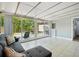 Bright living room featuring tiled floors, large windows, and sliding door access to the outdoor patio at 511 Glenoak N St, St Petersburg, FL 33703