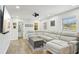 Spacious living room featuring a large sectional sofa and wood flooring at 511 Glenoak N St, St Petersburg, FL 33703