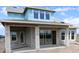 A modern home under construction with large windows, blue weatherproofing wrap, and a concrete block exterior at 5269 Everlong Dr, Apollo Beach, FL 33572