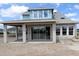 New construction home's rear exterior showing patio and block walls with new windows at 5269 Everlong Dr, Apollo Beach, FL 33572