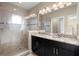 Modern bathroom featuring a double sink vanity, granite countertops, and a walk-in shower with glass doors at 5912 Anchorage S Way, St Petersburg, FL 33712