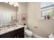 Charming half bathroom features granite countertop, modern fixtures, and window with plant at 5912 Anchorage S Way, St Petersburg, FL 33712