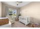 Serene Bedroom with a white crib, comfortable chair, and bright natural light at 5912 Anchorage S Way, St Petersburg, FL 33712