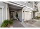 Inviting entrance featuring a well-lit porch, decorative plants, and a secure front door at 5912 Anchorage S Way, St Petersburg, FL 33712