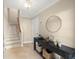 Bright foyer featuring tile floors, a staircase, and a decorative console table at 5912 Anchorage S Way, St Petersburg, FL 33712
