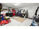 Cluttered garage featuring an organization station, work bench, and epoxy floors at 5912 Anchorage S Way, St Petersburg, FL 33712