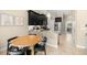Eat-in kitchen featuring dark cabinets, granite countertops, and stainless steel appliances at 5912 Anchorage S Way, St Petersburg, FL 33712