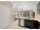 Open-concept kitchen with stainless steel appliances and a breakfast bar, leading to the living area at 5912 Anchorage S Way, St Petersburg, FL 33712