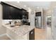 Modern kitchen features stainless steel appliances, granite countertops, and dark cabinets at 5912 Anchorage S Way, St Petersburg, FL 33712