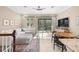 Bright and airy living room with a dining area, balcony access, and stylish decor at 5912 Anchorage S Way, St Petersburg, FL 33712