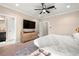 This main bedroom is spacious with a dresser, ceiling fan, ensuite bathroom and a cozy rug at 5912 Anchorage S Way, St Petersburg, FL 33712