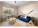 Bright playroom with natural light, featuring a blue couch and various toys for  at 5912 Anchorage S Way, St Petersburg, FL 33712