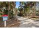 Tranquil walking path featuring a sign with trail information, surrounded by trees and natural vegetation at 5912 Anchorage S Way, St Petersburg, FL 33712