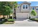 Exterior view of a two-story townhome with a garage and landscaping at 5922 Grand Sonata Ave, Lutz, FL 33558