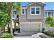 Charming townhouse featuring a two-car garage and meticulously landscaped front yard with lush greenery at 5922 Grand Sonata Ave, Lutz, FL 33558