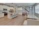 Bright, open kitchen with white cabinetry, stainless steel appliances, and a large island with bar seating at 5922 Grand Sonata Ave, Lutz, FL 33558