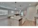 Stylish kitchen with an island, stainless steel appliances, and an open layout to the dining and living areas at 5922 Grand Sonata Ave, Lutz, FL 33558