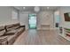Spacious living room featuring hardwood floors and a sliding glass door to the backyard at 5922 Grand Sonata Ave, Lutz, FL 33558