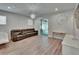 Bright living room with a large sofa, sliding glass door, and minimalist decor at 5922 Grand Sonata Ave, Lutz, FL 33558