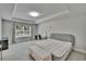 Cozy bedroom featuring a tray ceiling, a large window and plenty of natural light at 5922 Grand Sonata Ave, Lutz, FL 33558