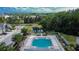 Stunning community pool and recreation area with beautiful landscaping and a tranquil pond at 5922 Grand Sonata Ave, Lutz, FL 33558