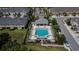 Aerial view of the community pool with lounge seating and manicured landscaping in a friendly neighborhood at 5922 Grand Sonata Ave, Lutz, FL 33558