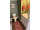 Cozy powder room with a decorative rug, and a small vanity cabinet at 6015 Shell Ridge Dr, Lithia, FL 33547