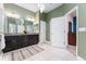 Bathroom showcasing dual sinks, a granite countertop and a door leading to closet at 6015 Shell Ridge Dr, Lithia, FL 33547