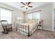 Bright bedroom with a decorative bed, rocking chair and carpeted floors at 6015 Shell Ridge Dr, Lithia, FL 33547