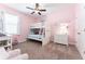Cheerful pink bedroom with bunk beds, carpeted floors, and decorative accents at 6015 Shell Ridge Dr, Lithia, FL 33547