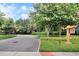 Inviting community entrance featuring lush landscaping and a decorative Lake House sign at 6015 Shell Ridge Dr, Lithia, FL 33547